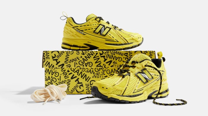 Side view of yellow and black New Balance shoes.
